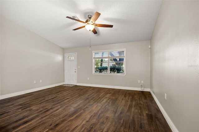 unfurnished room with lofted ceiling, ceiling fan, a textured ceiling, and dark hardwood / wood-style flooring