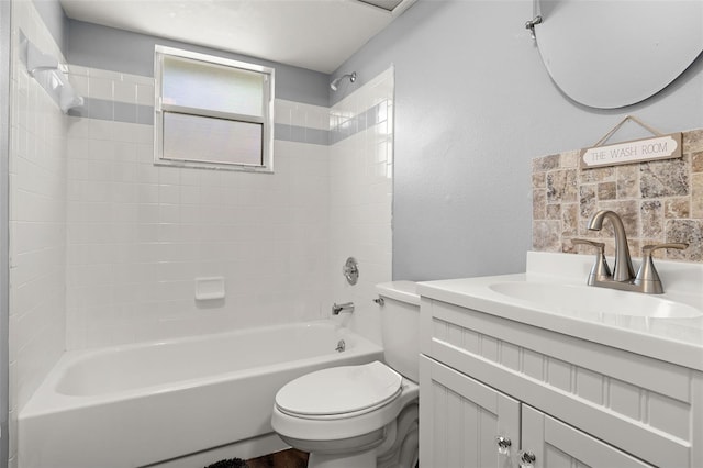 full bathroom featuring vanity, toilet, and tiled shower / bath combo