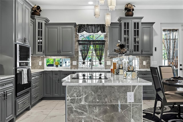 kitchen with a center island, stainless steel appliances, and gray cabinets