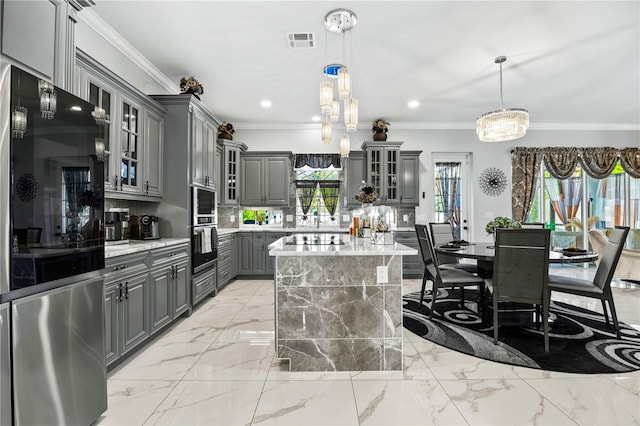 kitchen featuring gray cabinets, oven, a kitchen island, and pendant lighting