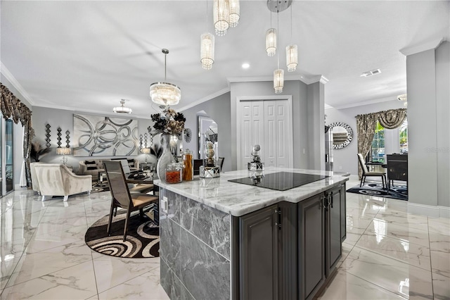 kitchen featuring pendant lighting, black electric cooktop, ornamental molding, dark brown cabinets, and light stone counters