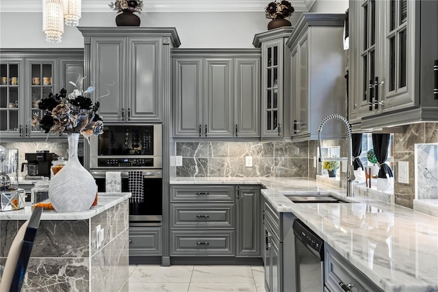 kitchen with gray cabinetry, sink, ornamental molding, appliances with stainless steel finishes, and light stone counters