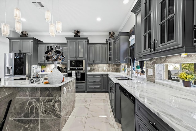 kitchen with decorative backsplash, appliances with stainless steel finishes, ornamental molding, gray cabinetry, and hanging light fixtures