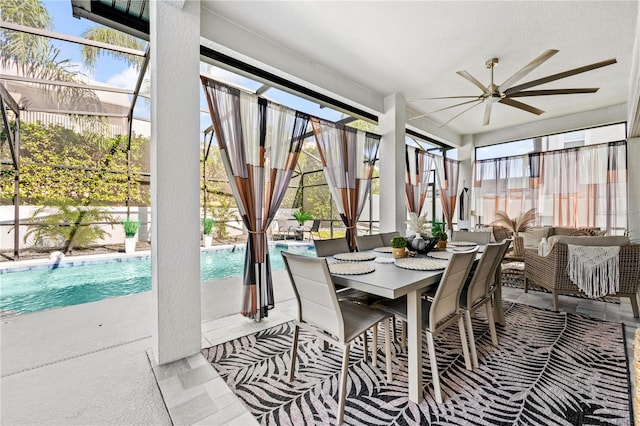 sunroom featuring ceiling fan and plenty of natural light