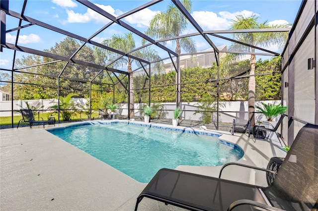 view of pool featuring glass enclosure, a patio area, and pool water feature