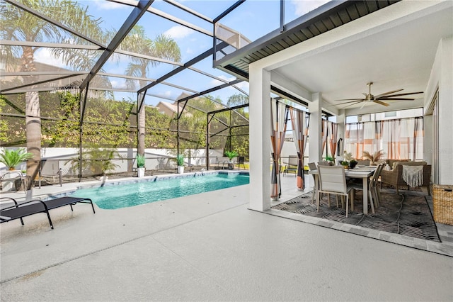 view of pool featuring a lanai, pool water feature, ceiling fan, and a patio area