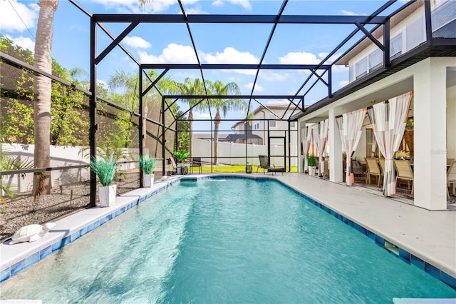 view of swimming pool featuring a patio and a lanai