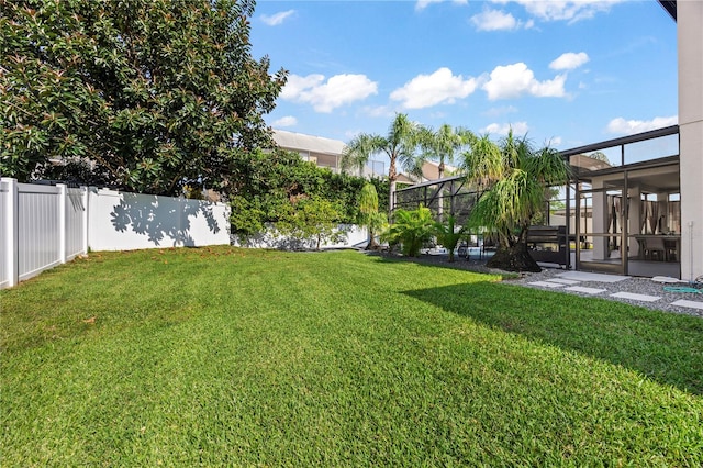 view of yard with a lanai