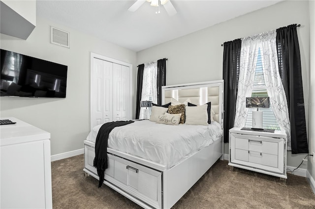 carpeted bedroom featuring ceiling fan and a closet