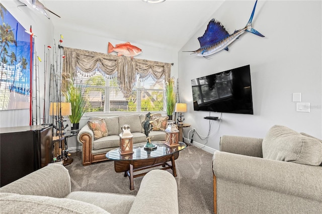 carpeted living room featuring lofted ceiling