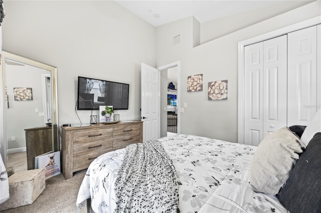 carpeted bedroom featuring a closet and a towering ceiling