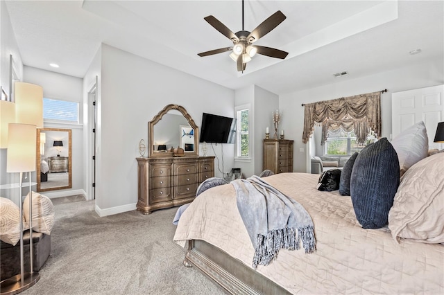 bedroom featuring multiple windows, ceiling fan, and carpet