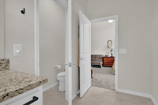 bathroom featuring toilet, vanity, and tile patterned floors