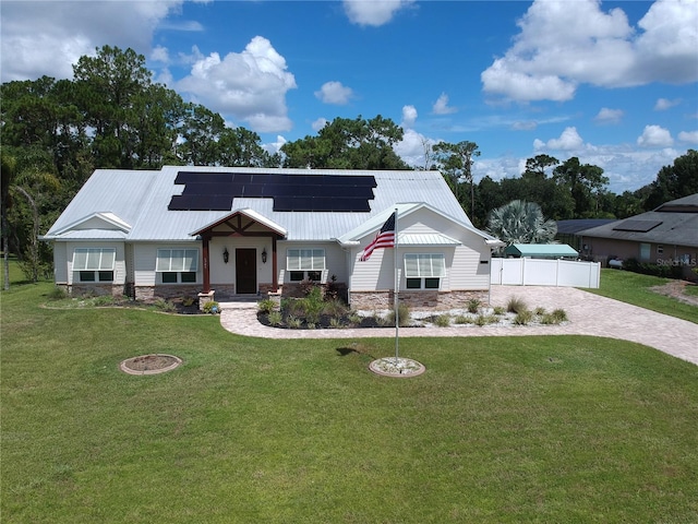 view of front of house with solar panels and a front yard