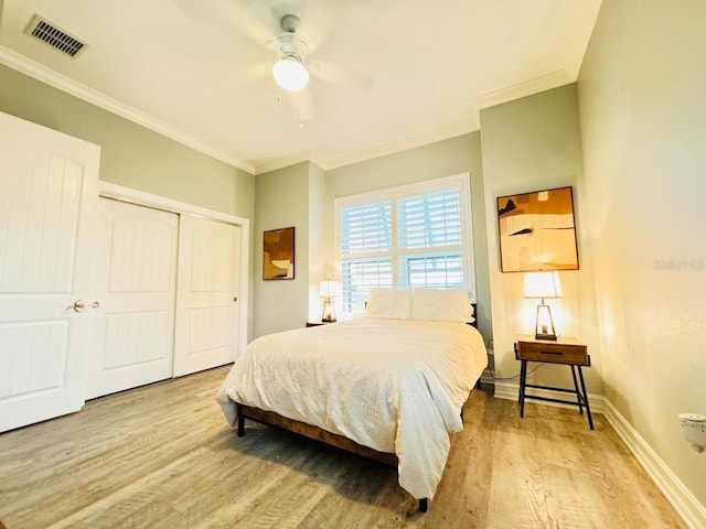 bedroom with a closet, ceiling fan, ornamental molding, and light hardwood / wood-style floors