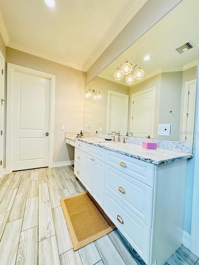 bathroom with vanity, ornamental molding, and hardwood / wood-style flooring