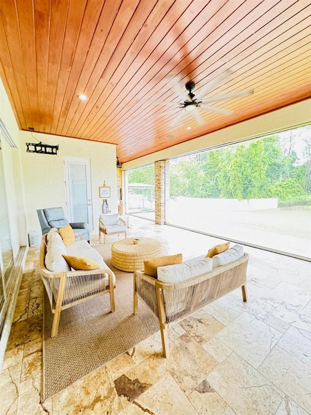 sunroom / solarium with ceiling fan and wooden ceiling