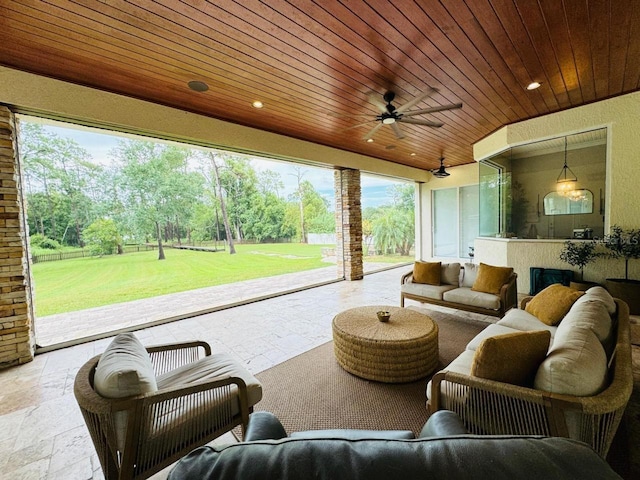 view of patio with an outdoor living space and ceiling fan