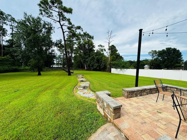 view of yard featuring a water view and a patio area