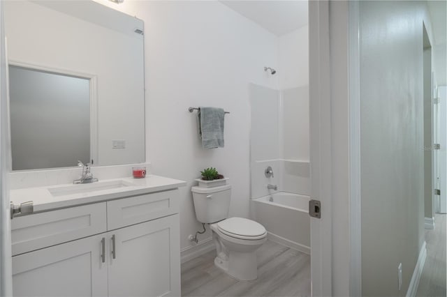 full bathroom with vanity, toilet, hardwood / wood-style flooring, and shower / bathtub combination