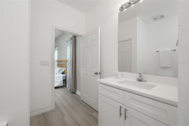 bathroom featuring vanity and hardwood / wood-style flooring