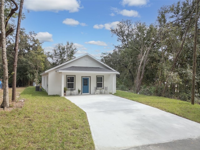 view of front of home with a front lawn, central air condition unit, and a porch