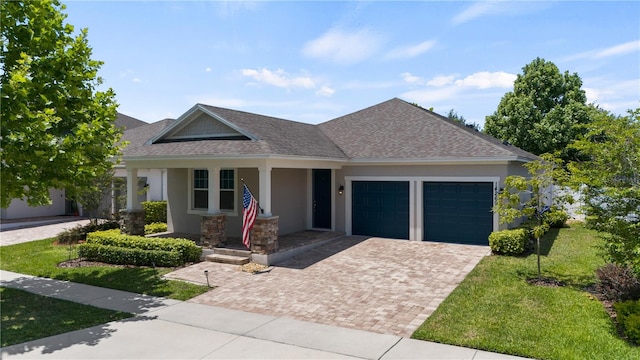 view of front of property featuring a garage and a front lawn