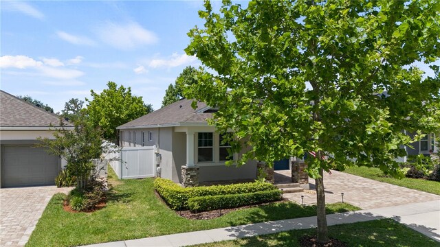 view of front of house with a garage and a front lawn