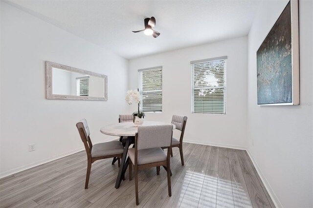 dining room featuring ceiling fan and light hardwood / wood-style flooring