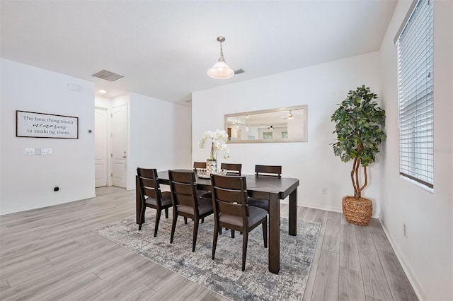 dining space featuring light wood-type flooring