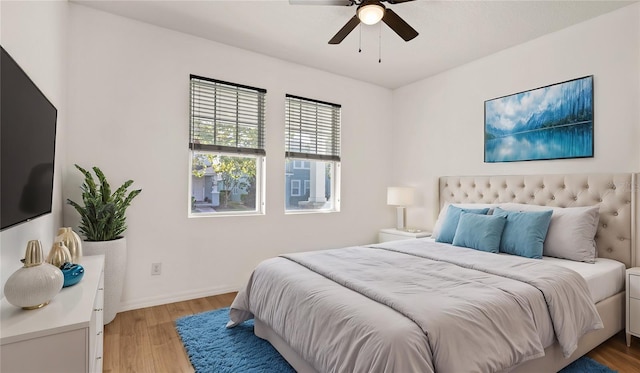 bedroom with light wood-type flooring and ceiling fan