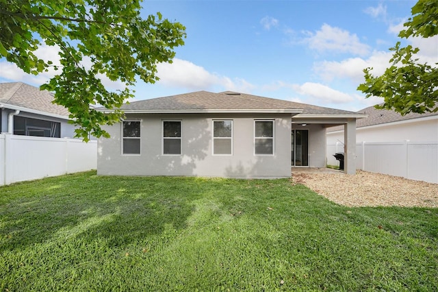 rear view of house with a lawn