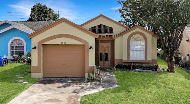 mediterranean / spanish house with a garage and a front yard