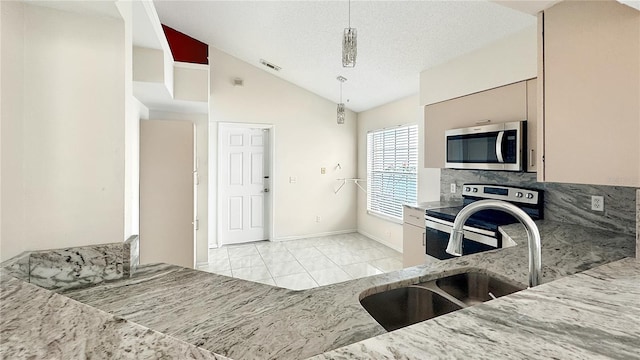 kitchen featuring stainless steel appliances, sink, a textured ceiling, high vaulted ceiling, and hanging light fixtures