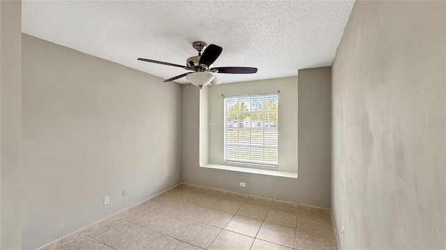 tiled spare room featuring a textured ceiling and ceiling fan