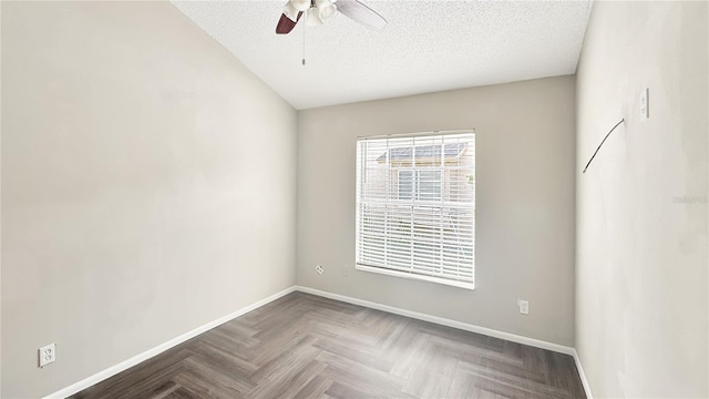 unfurnished room with parquet flooring, ceiling fan, and a textured ceiling