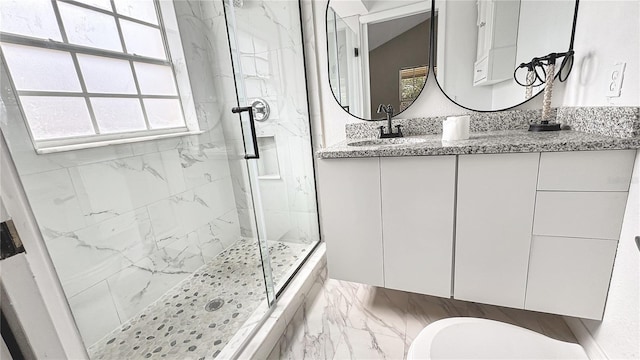 bathroom featuring vanity and a shower with door