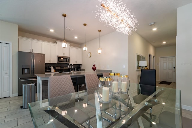 dining area with a notable chandelier and light tile patterned floors