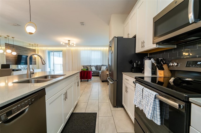 kitchen featuring appliances with stainless steel finishes, white cabinetry, and sink