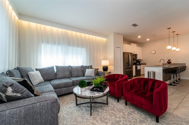 living room with sink and light tile patterned flooring