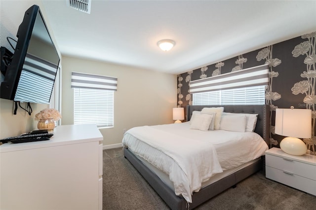 carpeted bedroom featuring multiple windows