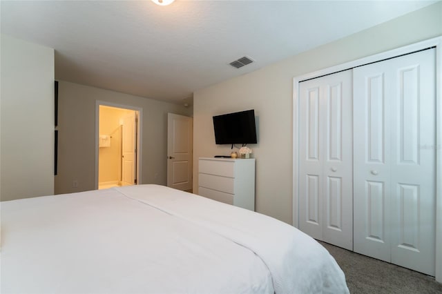 bedroom with a closet, a textured ceiling, and carpet floors