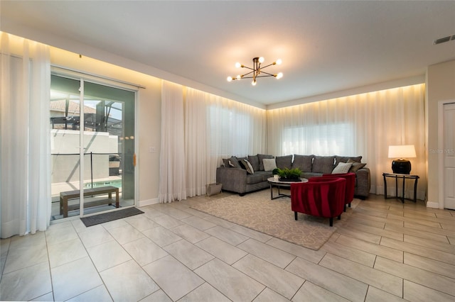 living room featuring a wealth of natural light and an inviting chandelier