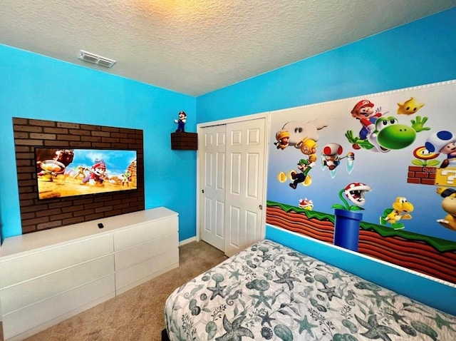 carpeted bedroom featuring a closet and a textured ceiling