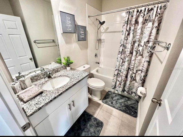 full bathroom featuring vanity, toilet, shower / bath combo with shower curtain, and tile patterned flooring