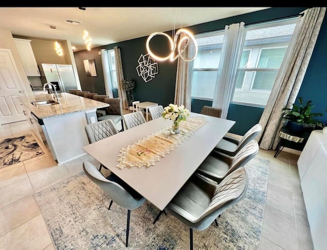 dining room featuring light tile patterned floors and sink