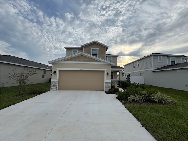 view of front of property with a front yard and a garage