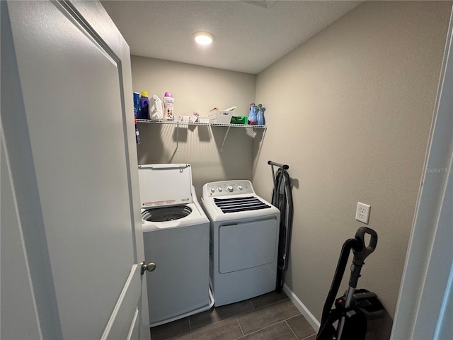 laundry room with washer and clothes dryer and a textured ceiling