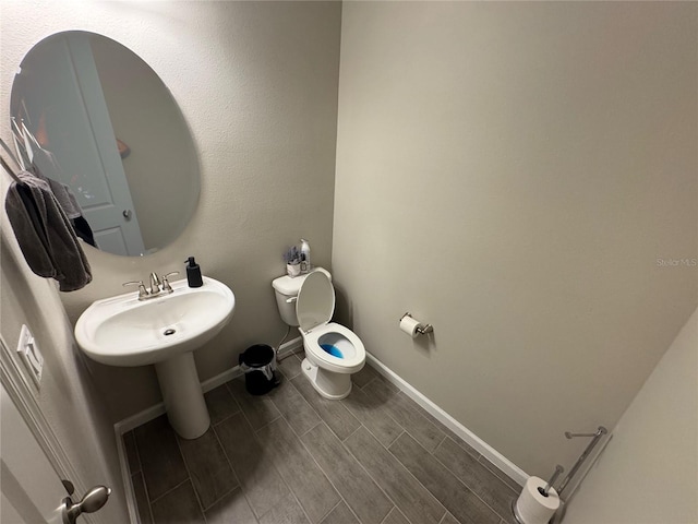 bathroom featuring hardwood / wood-style floors and toilet