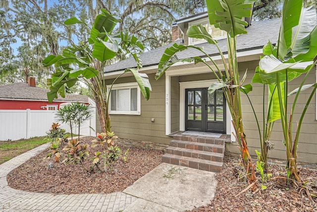 734 S Mills Ave, Orlando, FL 32801 - doorway to property with fence, french doors, a shingled roof, and a chimney